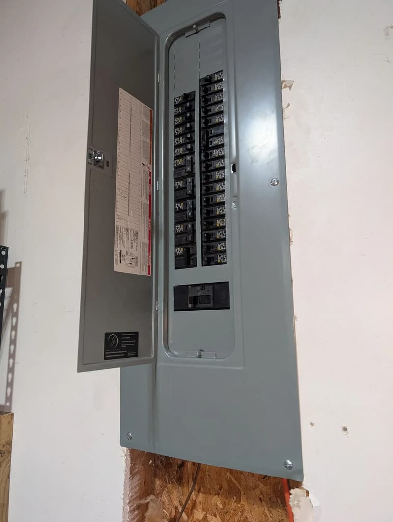 Open breaker panel mounted on wall